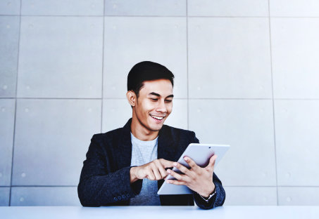happy man using his tablet device